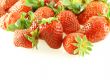 lots of fresh strawberries over white