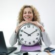 Smiling woman with clock