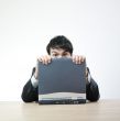 Man afraid behind computer