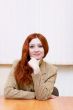 Attractive redhead woman in classic suit