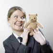 Woman playing with teddy