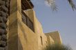 An arabic house balcony shaded by palm trees