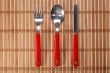 Spoon, fork and knife on bamboo background