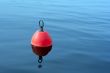 red-orange buoy in the blue water