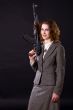 smiling businesswoman wtith submachine gun