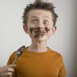 Boy`s face dirty with chocolate