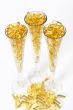 Three glasses with gold boluses
