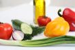 Multi-coloured vegetables for salad on a white background