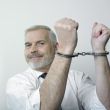 Happy handcuffed man