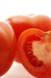 close up shot of ripe juicy tomatoes over white