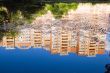 Blue sky and rose build, reflection in deep pond