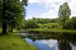 Blue reflection in river  at summer forest, Russia