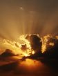 dramatic sundown scene with dark clouds and rays