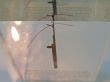 Needle in glass with candle
