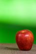 red apple with green background
