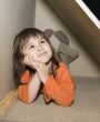 Child girl hiding in wooden box, dreams alone