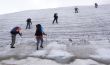 Six people trekking on a glacier.