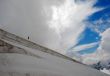 Climber making their descent down a snowy slope