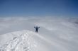 Climber standing on top of mountain