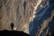 Silhouette of a man over a rock.