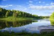 Blue reflection in river  at summer forest, Russia