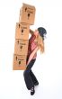 Woman with cardboard boxes ready to fall