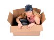 Cute girl sitting in a cardboard box