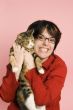 young woman holding domestic cat