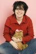 young beautiful woman holding a red domestic cat
