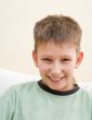 Smiling teenager sit on white sofa