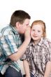 young boy is whispering
