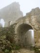 age-old stronghold gate arched mist morning