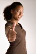 Woman is holding her thumb up