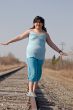Girl Balancing On Railroad Tracks