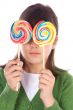 Girl eating two lollipops