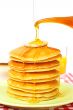 Pouring syrup on the pancakes