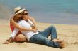Romantic couple sitting on the beach
