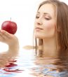 woman with red apple in water