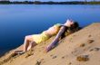 blond girl lying on the beach