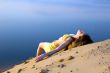 blond girl lying on the beach