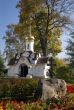 Small chapel among flowers and fall golden trees