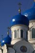 white-blue church onion domes against blue sky