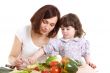 mother and daughter cooking at the kitchen