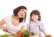 mother and daughter cooking at the kitchen