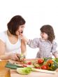 mother and daughter cooking at the kitchen