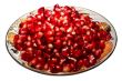 Pomegranate grains on a plate.  Isolated on white.
