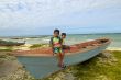 two kids relaxing on top of a fishing boat