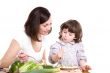 mother and daughter cooking at the kitchen