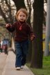 Little girl running to photographer or audience.