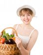 girl holding a basket of delicious fresh vegetables.